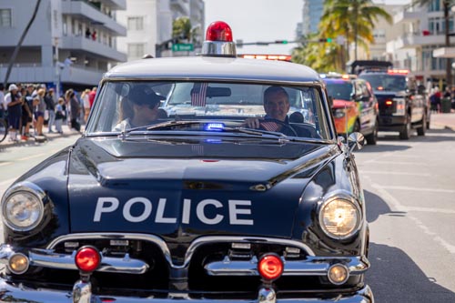 Mayor Meiner driving vintage police car