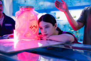 girl looking at red hued objected