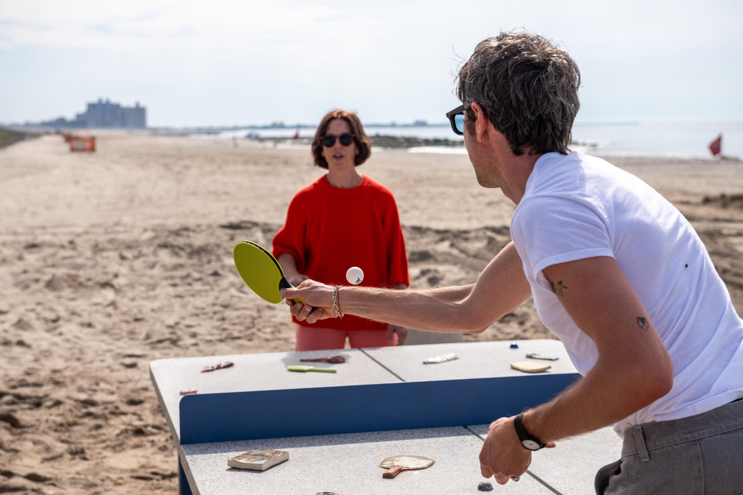 man and woman playing ping pong